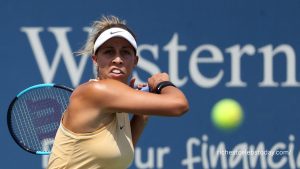 Madison Keys holding tennis racket on court